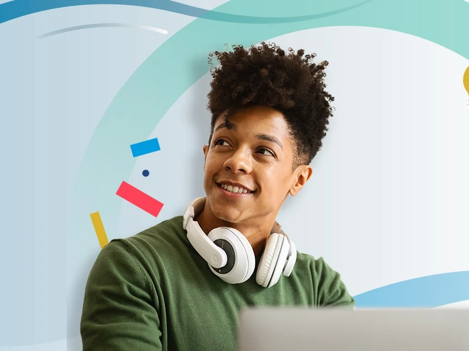 A smiling learner with headphones around their neck, looking up
