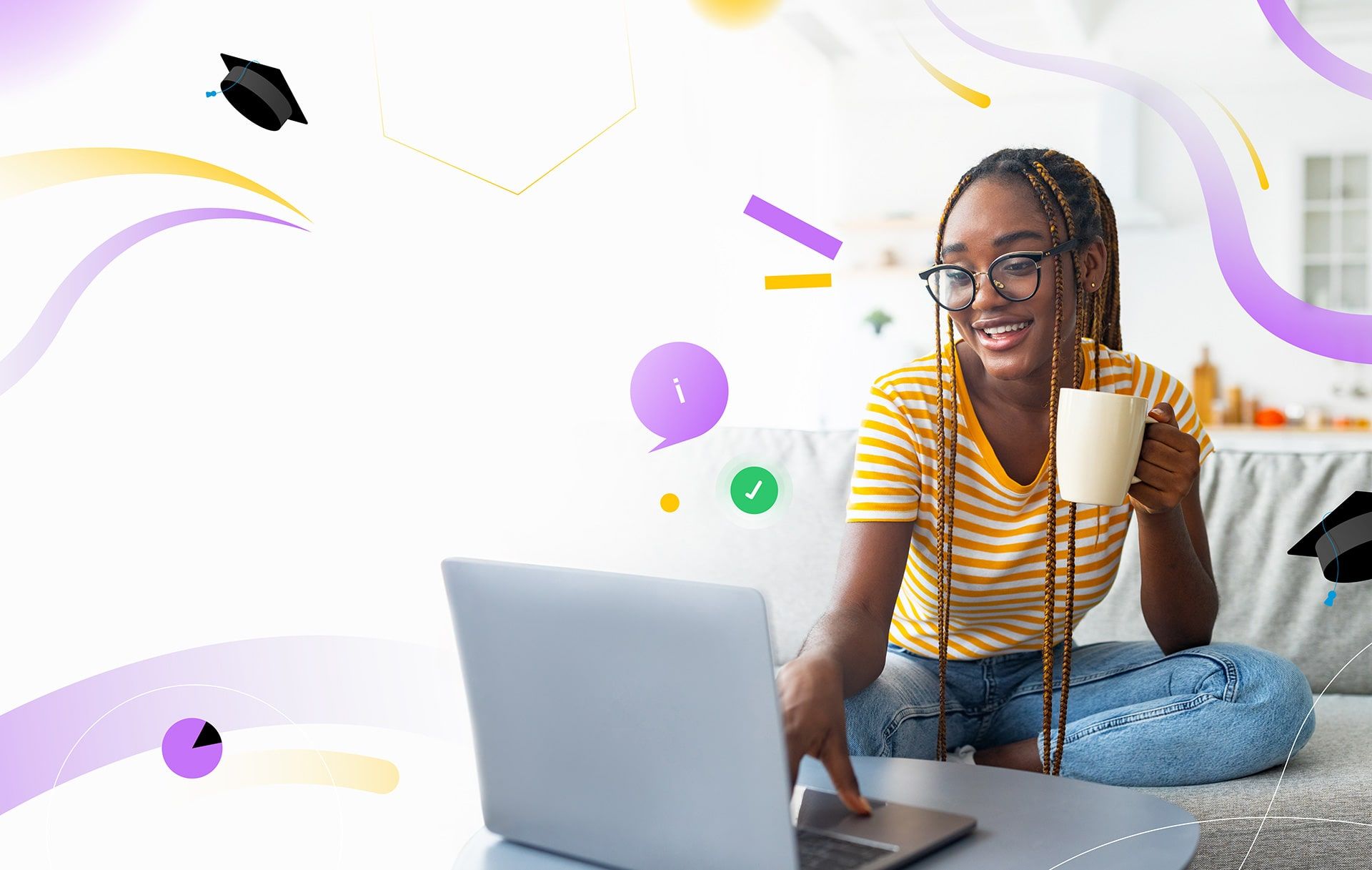 A smiling learner with a cup of tea working on a laptop