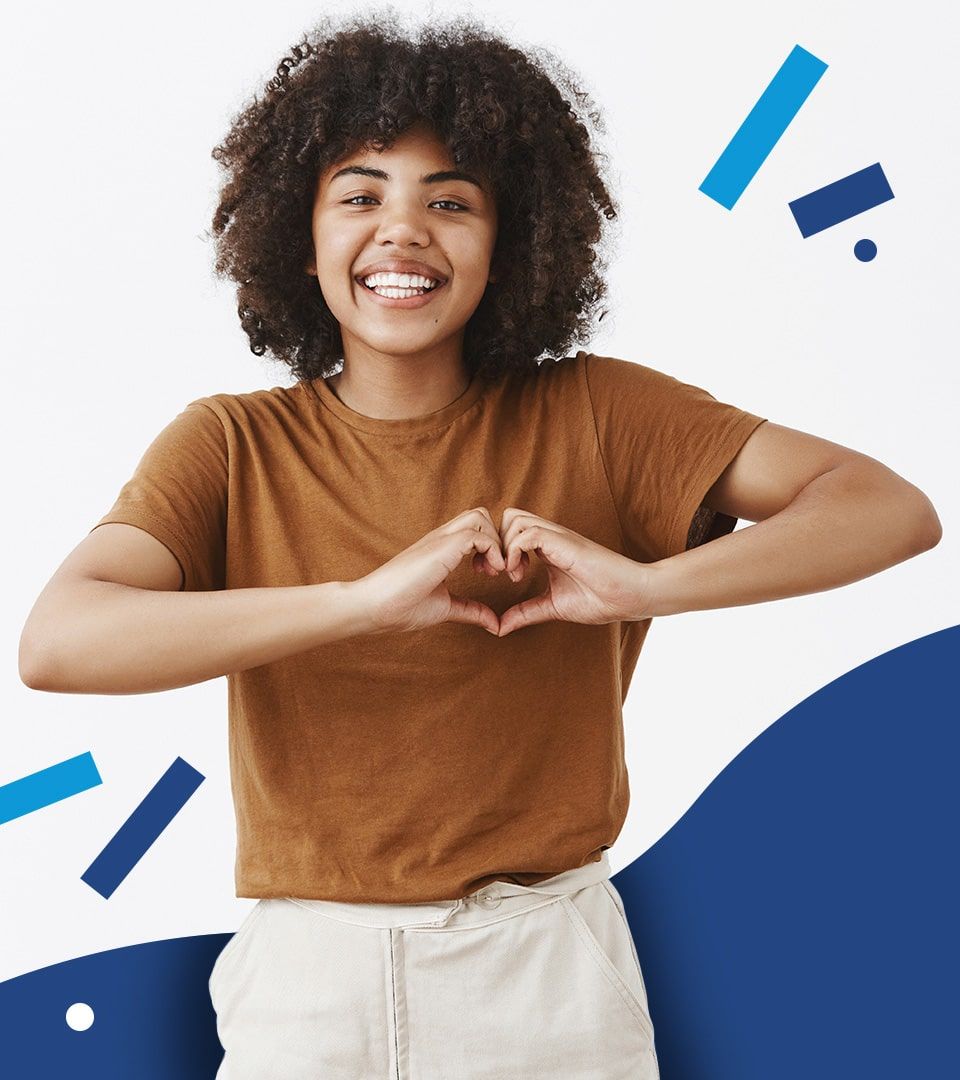 A smiling learner making a heart shape with their hands