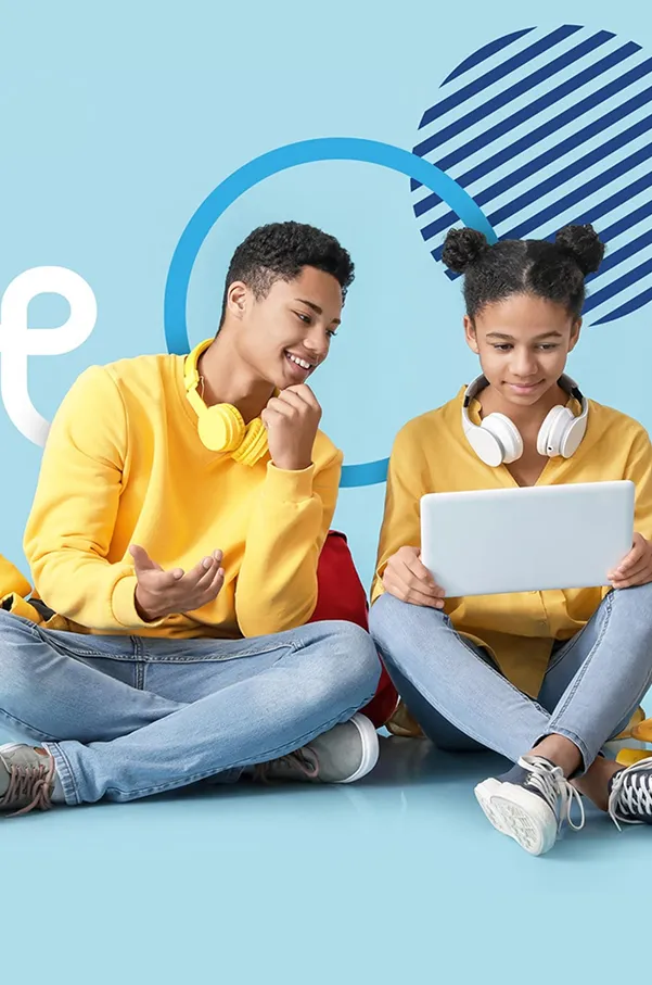 Two learners sitting together, one pointing at a tablet